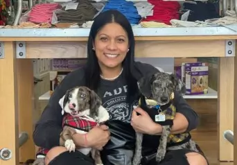 Juliana holding two puppies