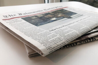 Image of a folded newspaper on a desk