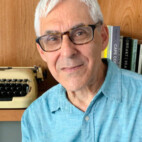 Photo of Ed Miller in front of a book shelf