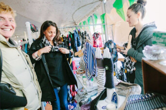 Three people shopping at a local shop with smiles