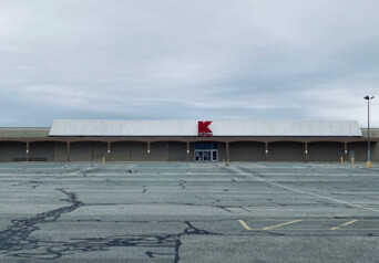 Photo of Kmart store in the distance with an empty parking lot