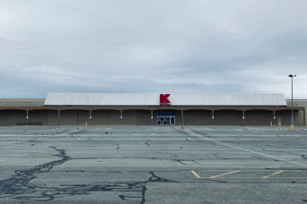 Photo of Kmart store in the distance with an empty parking lot